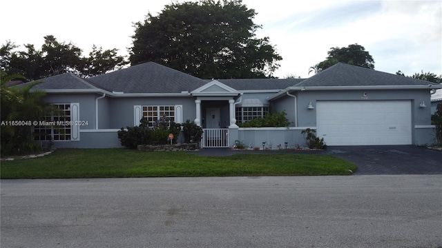 ranch-style house with a garage and a front yard