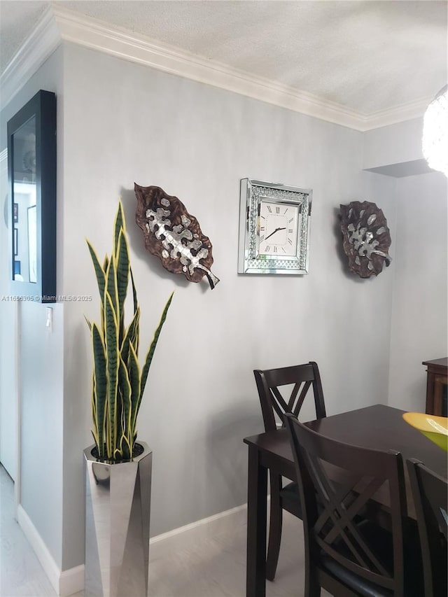 dining space with crown molding