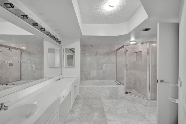 bathroom featuring independent shower and bath, a textured ceiling, and vanity