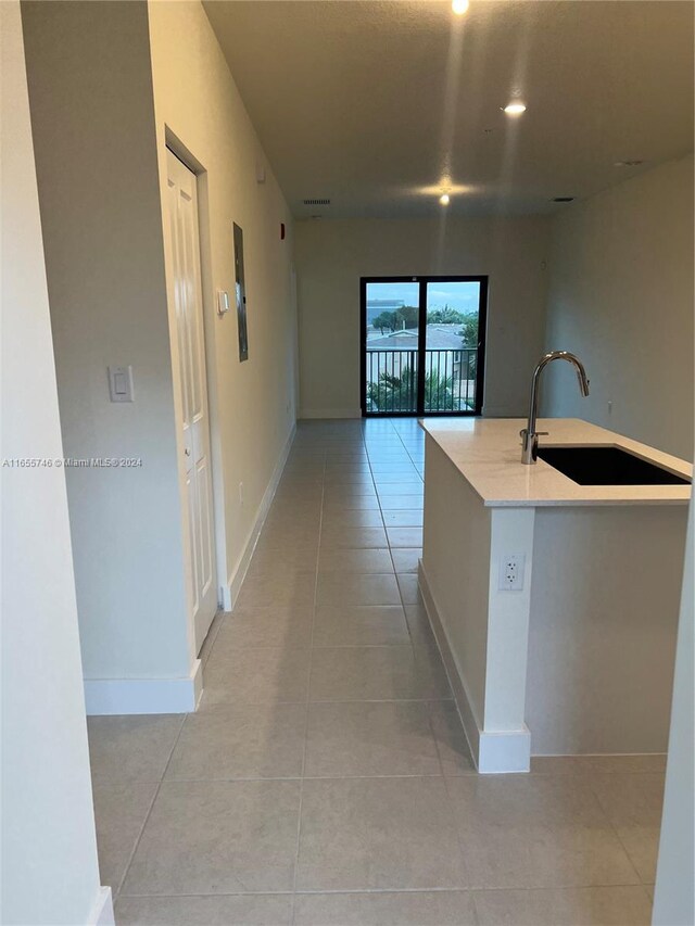 8001 NW 41st St Unit F-310, Doral, FL 33166 - hall with light tile patterned floors, a sink, baseboards, and recessed lighting