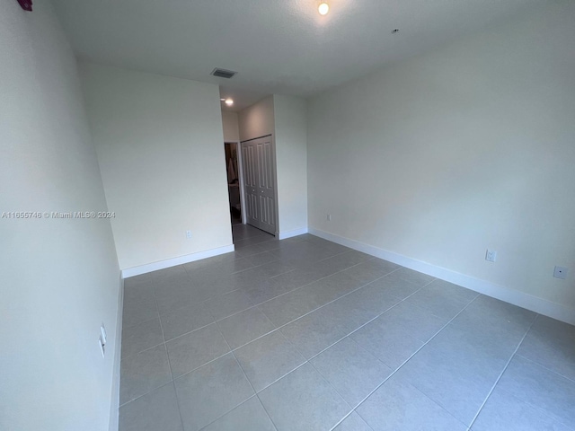 empty room with tile patterned floors