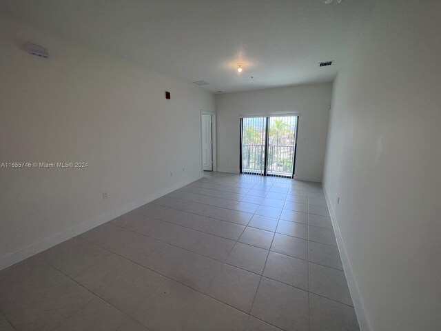 8001 NW 41st St Unit F-310, Doral, FL 33166 - unfurnished room with light tile patterned floors and baseboards
