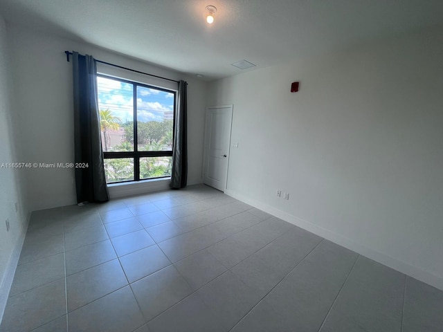 empty room with light tile patterned flooring