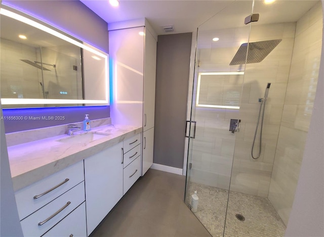 bathroom featuring vanity and a shower with shower door