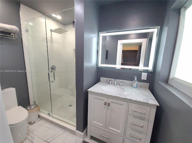 bathroom with an enclosed shower, vanity, and toilet