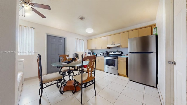 kitchen featuring stainless steel appliances, light tile patterned floors, and ceiling fan