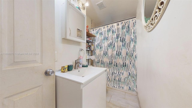 clothes washing area featuring light tile patterned floors and sink