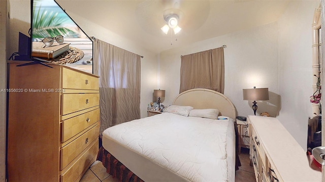 tiled bedroom featuring ceiling fan