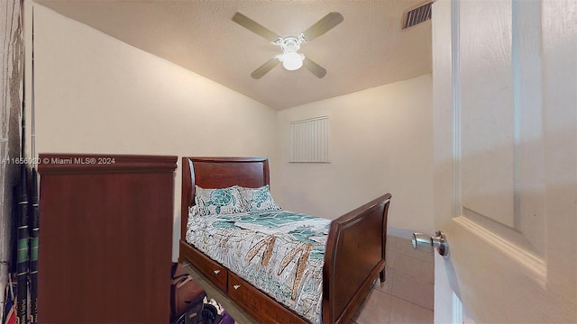 bedroom featuring lofted ceiling, tile walls, ceiling fan, and a textured ceiling