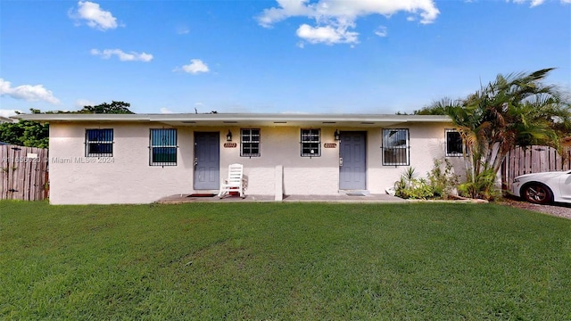 ranch-style home with a front lawn