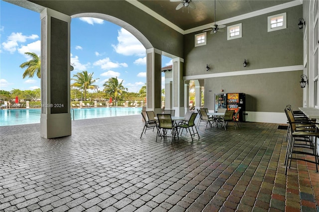 view of patio featuring a community pool and ceiling fan