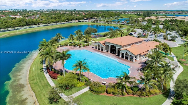 view of swimming pool featuring a patio and a water view