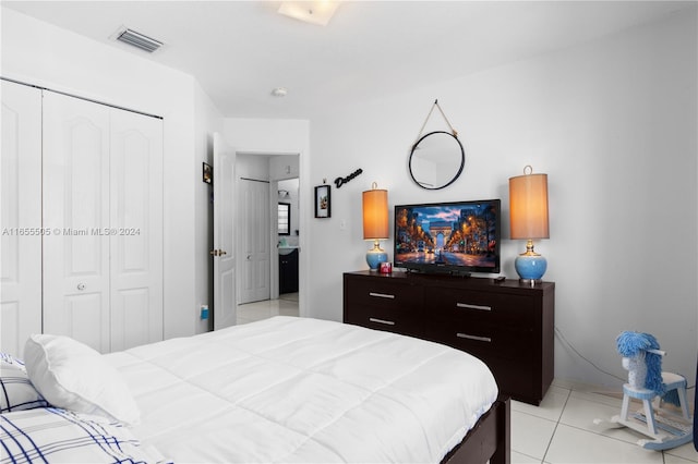 bedroom featuring light tile patterned flooring and a closet