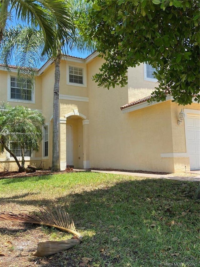 mediterranean / spanish-style home with a front yard