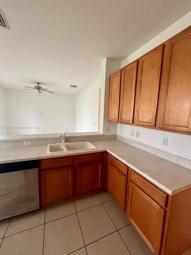 kitchen with dishwasher, sink, ceiling fan, light tile patterned flooring, and kitchen peninsula