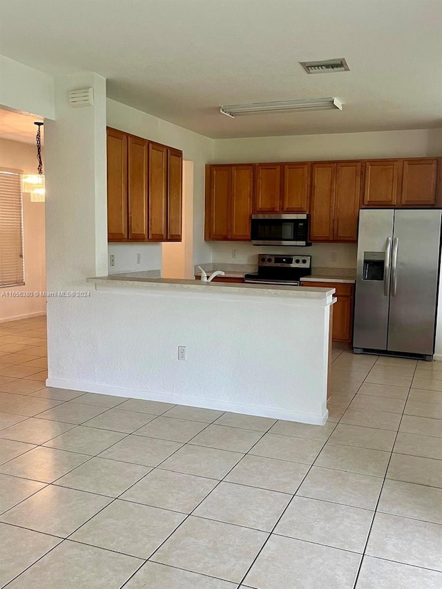 kitchen with light tile patterned floors and appliances with stainless steel finishes