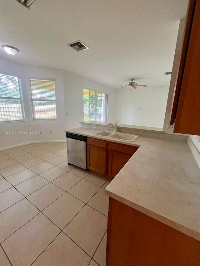 kitchen with stainless steel dishwasher, ceiling fan, light tile patterned floors, and sink