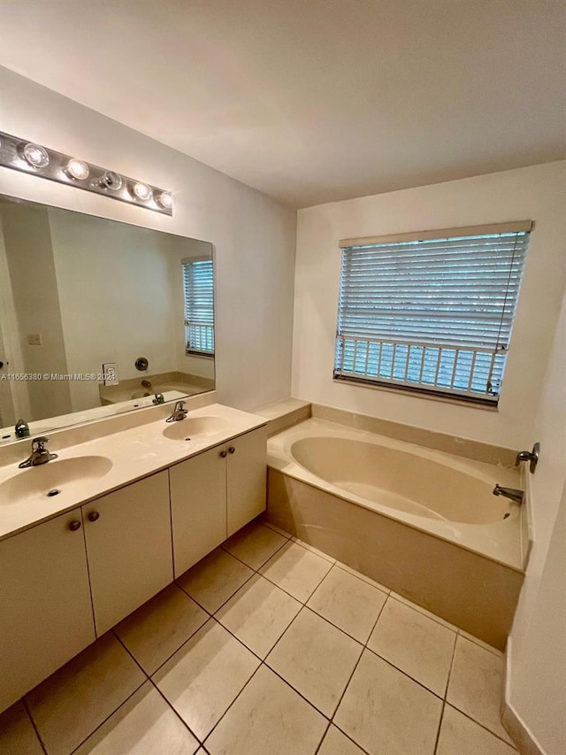 bathroom with a bathing tub, tile patterned flooring, and vanity