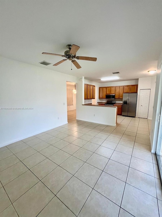 unfurnished living room with ceiling fan and light tile patterned floors