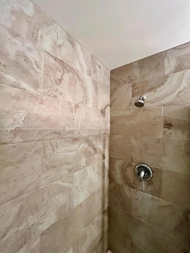 bathroom with a tile shower