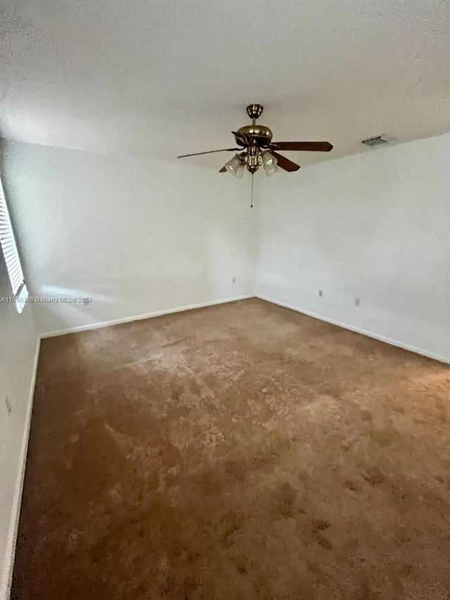 unfurnished room with carpet floors and a textured ceiling