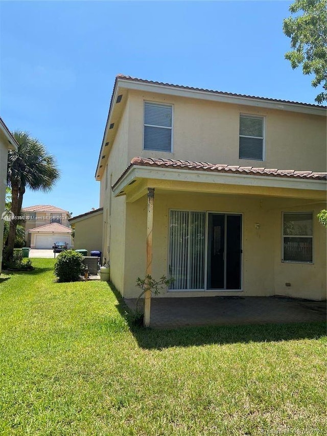 rear view of house with a patio area and a yard