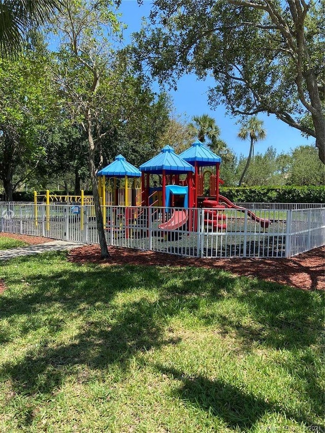 view of jungle gym featuring a lawn