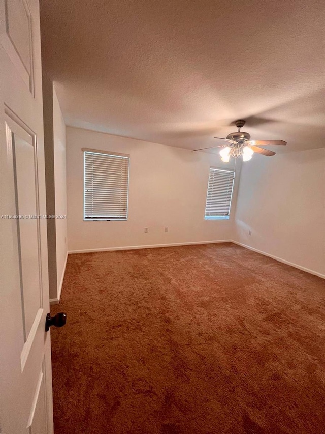 carpeted spare room with ceiling fan and a textured ceiling