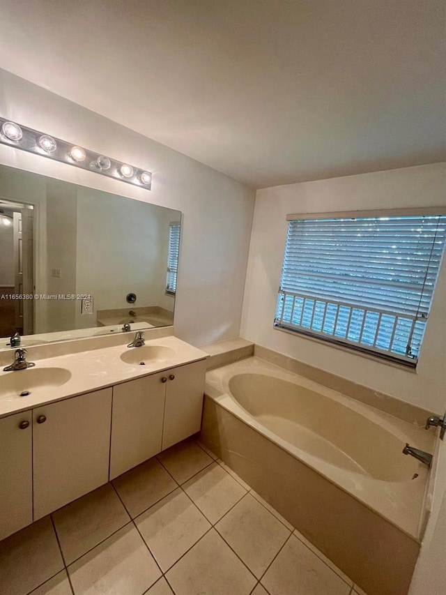 bathroom with tile patterned floors, vanity, and a tub to relax in