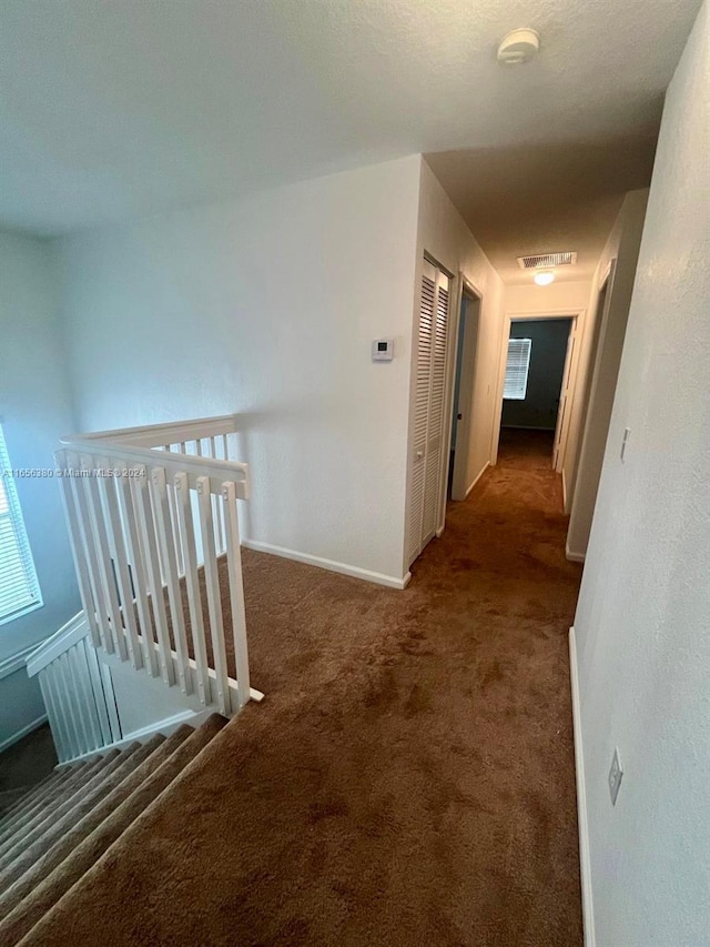 hallway with dark carpet