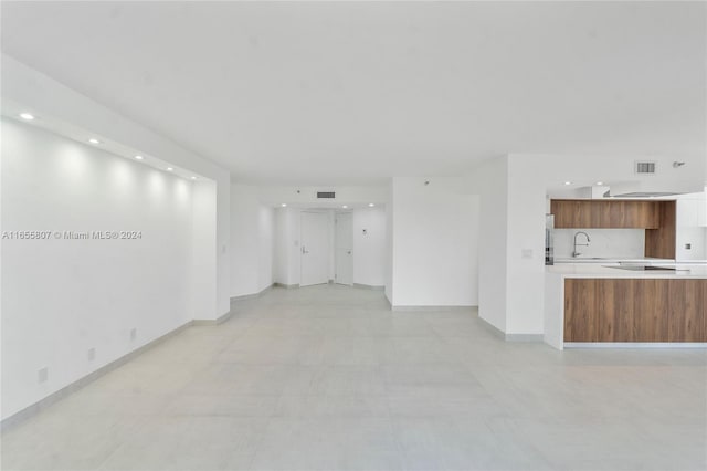 unfurnished living room featuring sink