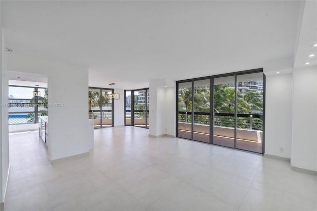 unfurnished room featuring a wall of windows