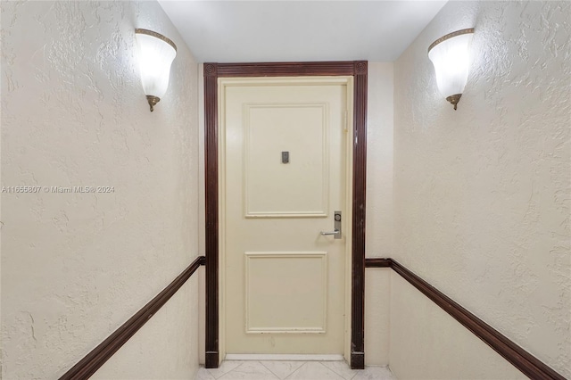 corridor with light tile patterned flooring