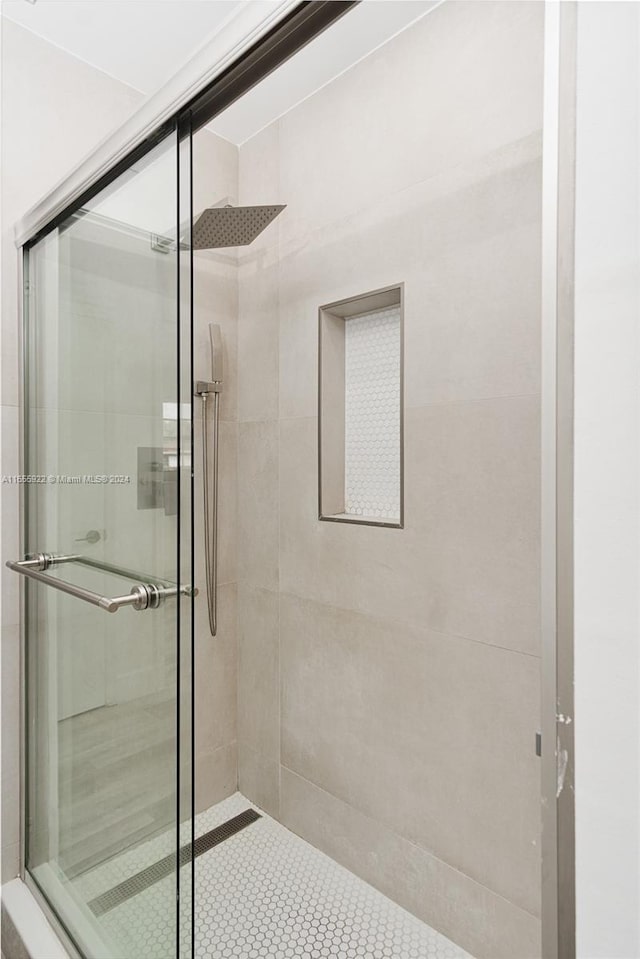 bathroom featuring a shower with shower door