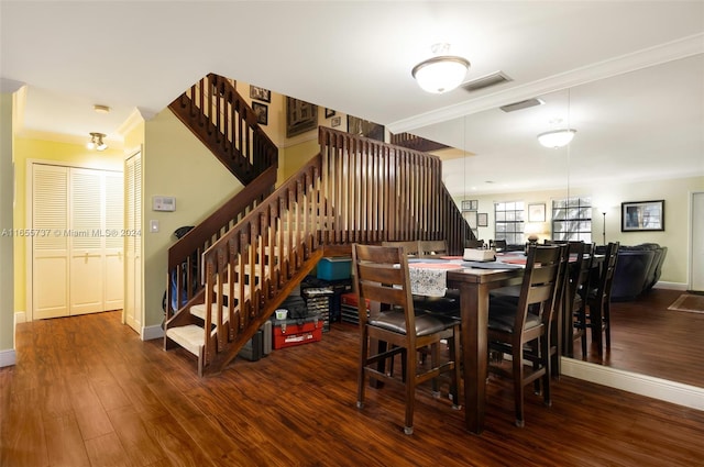 dining space with dark hardwood / wood-style floors and ornamental molding