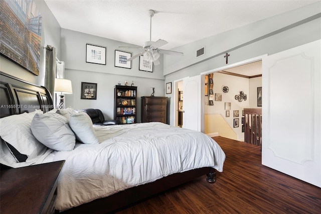 bedroom with crown molding, ceiling fan, and dark hardwood / wood-style flooring