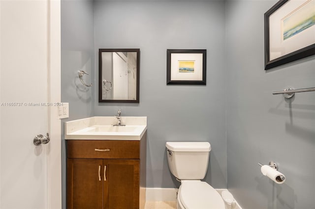 bathroom with vanity, toilet, and tile patterned floors