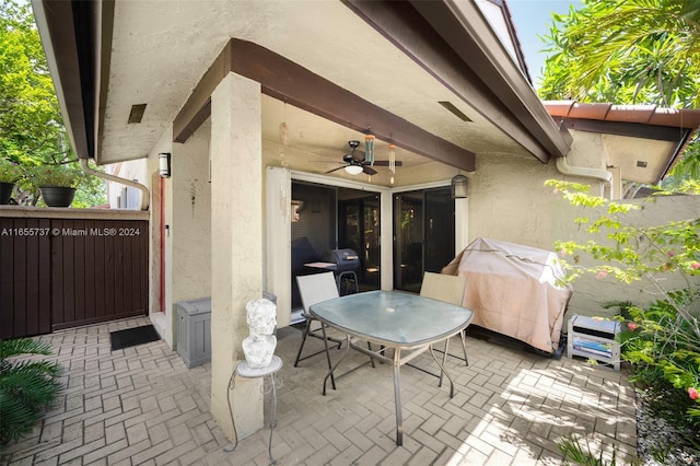 view of patio with area for grilling and ceiling fan