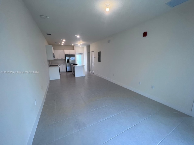 unfurnished living room featuring light tile patterned floors