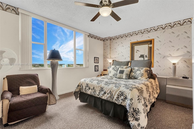 carpeted bedroom featuring a textured ceiling and ceiling fan