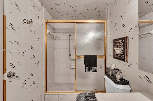 bathroom with toilet and an enclosed shower