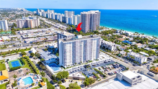 birds eye view of property with a water view and a city view