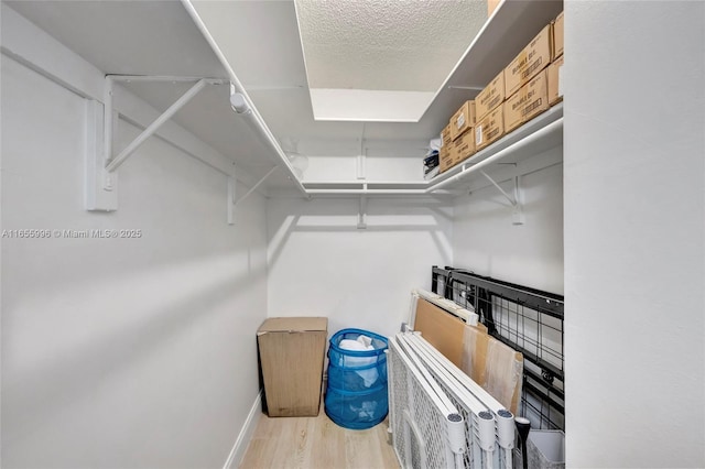 spacious closet with wood finished floors