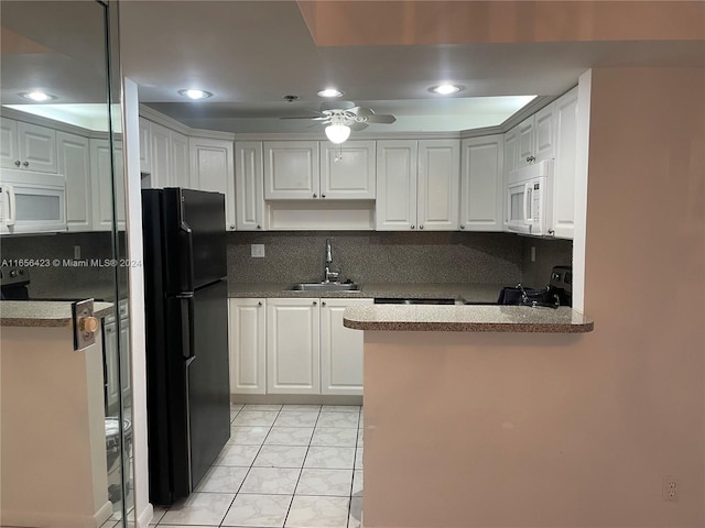 kitchen with white cabinetry, black refrigerator, sink, electric range, and ceiling fan