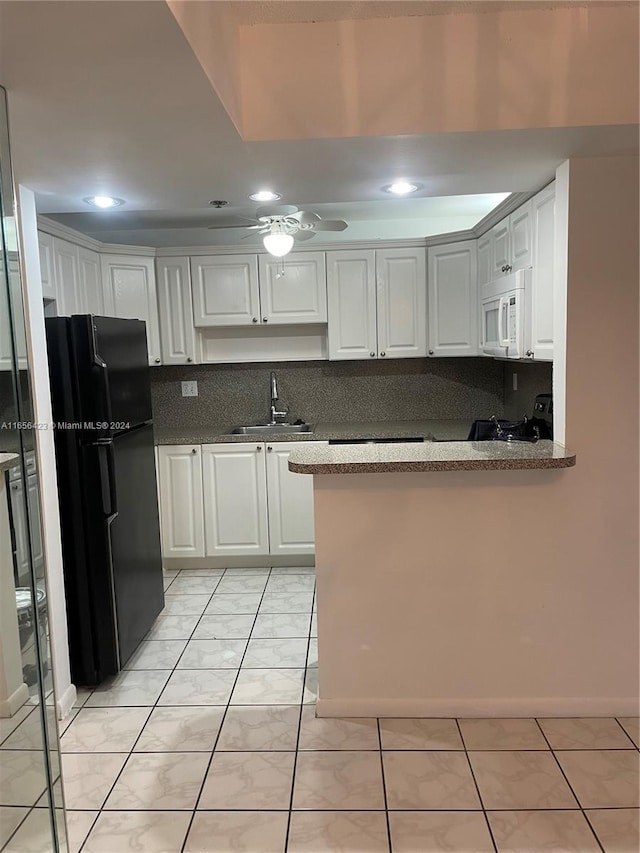 kitchen featuring black appliances, backsplash, kitchen peninsula, sink, and white cabinets