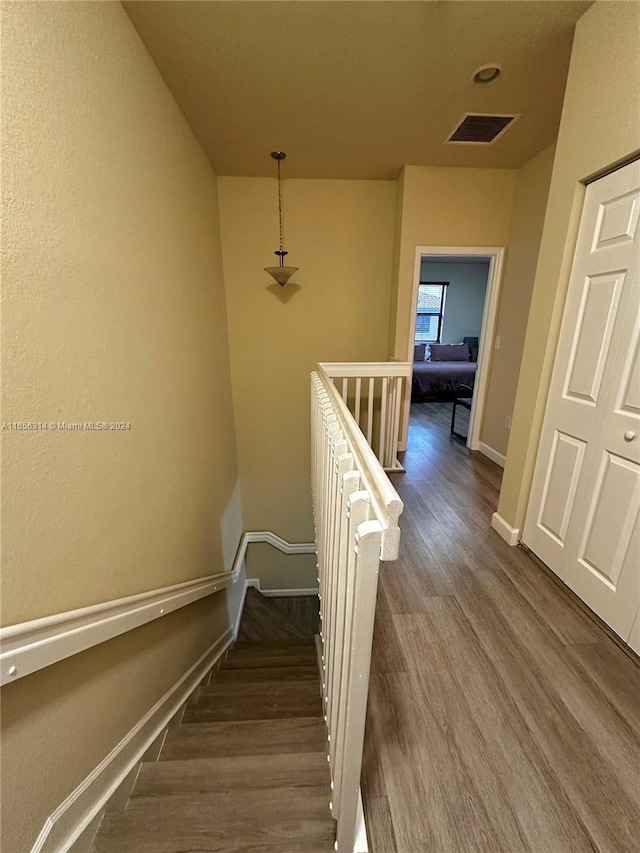 staircase with wood-type flooring