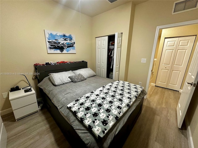 bedroom with wood-type flooring and a closet