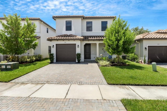 mediterranean / spanish-style house featuring a garage and a front yard