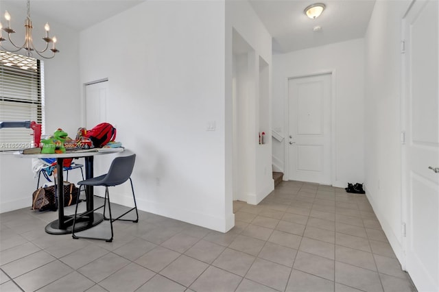 interior space featuring an inviting chandelier and light tile patterned flooring