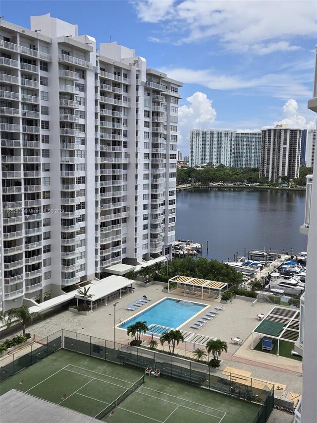 exterior space with a community pool and a water view